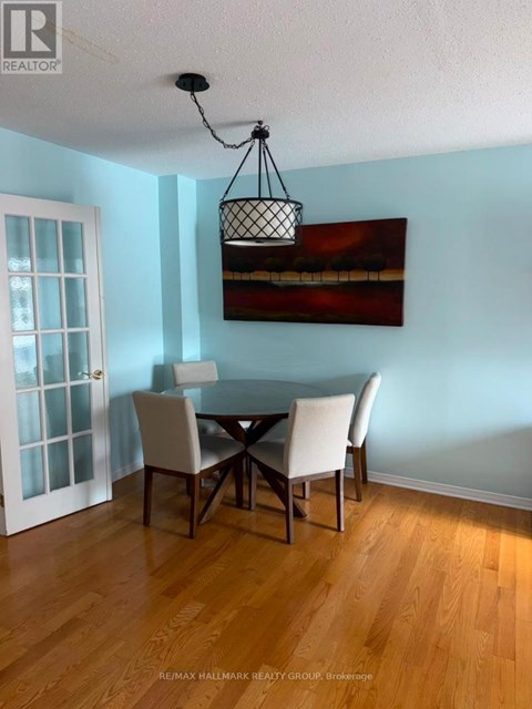 A dining room with a table and chairs.