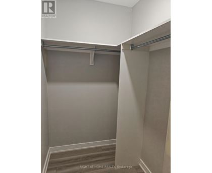 A room with a grey wall and a grey floor.
