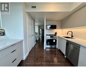 A modern kitchen with white cabinets and a stainless steel dishwasher.