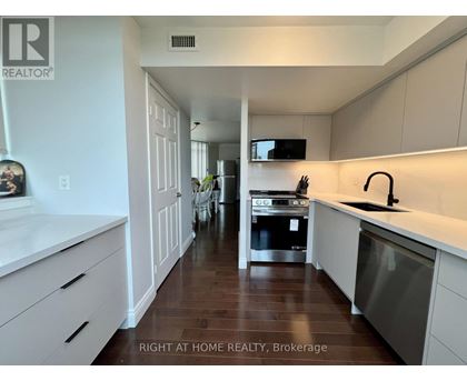 A modern kitchen with white cabinets and a stainless steel dishwasher.