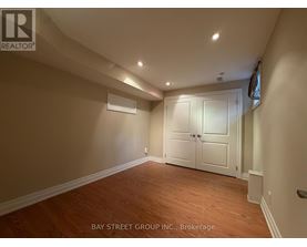 A room with wooden flooring and a white door.