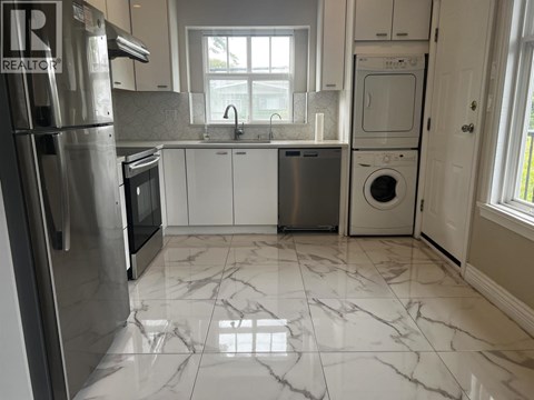 A kitchen with a marble floor and white cabinets.