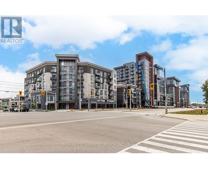 A street view of a city with buildings and a pedestrian crossing.