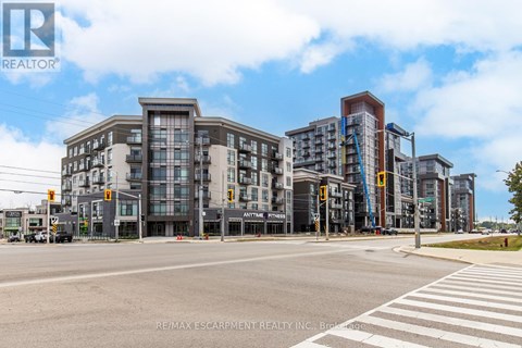 A street view of a city with buildings and a pedestrian crossing.