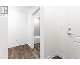 A white door is open to a hallway.