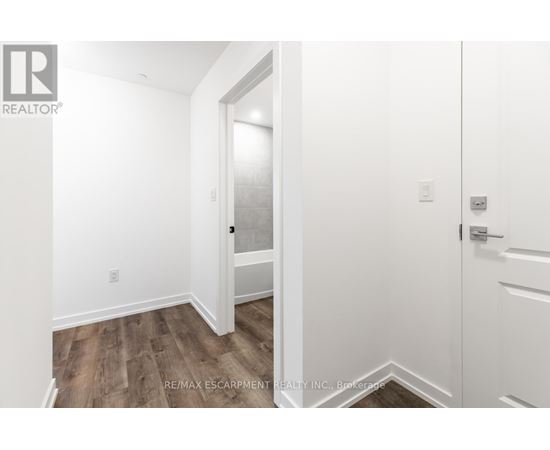 A white door is open to a hallway.