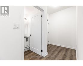 A white door in a room with a wooden floor.