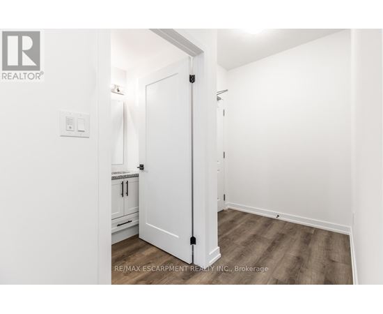 A white door in a room with a wooden floor.