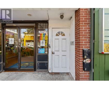 A realtor office with a white door and a glass window.