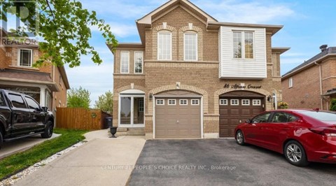 A two-story house with a garage and a car parked in front.