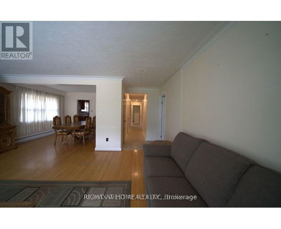A living room with a couch and a dining table.