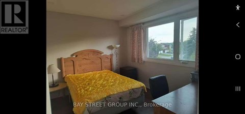 A bedroom with a bed, desk, and chair is shown.