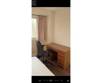 A room with a desk and a chair.
