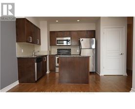 A kitchen with brown cabinets and stainless steel appliances.