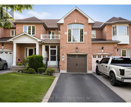 A large brick house with a white truck parked in front.
