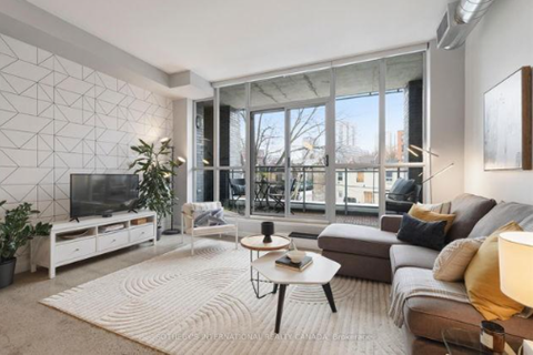 A modern living room with a white sofa set and a television.