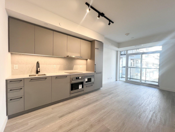 A modern kitchen with a large island and stainless steel appliances.