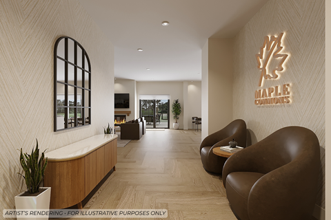 A modern waiting area with a wooden reception desk and two brown leather chairs.