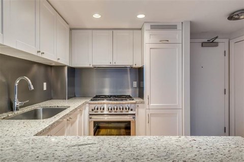 A kitchen with a stove and sink.