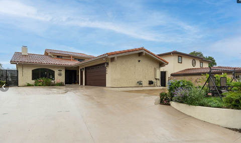 A house with a driveway in front of it.