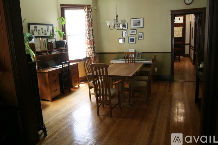 A dining room with a wooden table and chairs.
