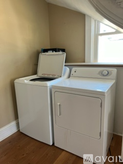 A white washing machine and dryer in a room.