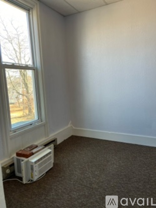 A room with a window and a white console.