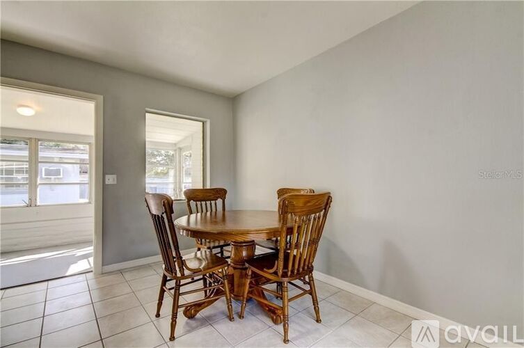 A dining room with a table and chairs.