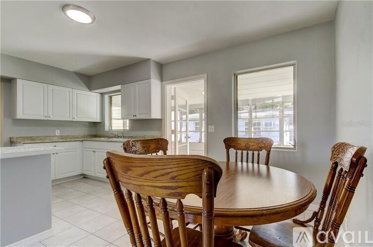 A kitchen with a table and chairs in the foreground.