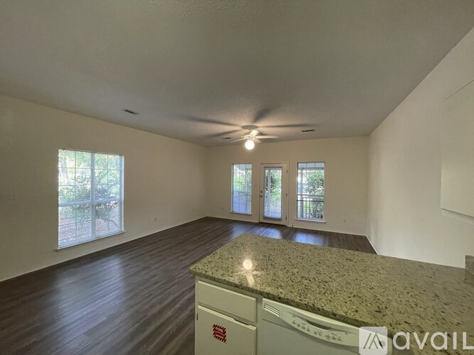 A room with a granite countertop and a ceiling fan.