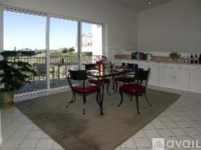 A dining room with a table and chairs.