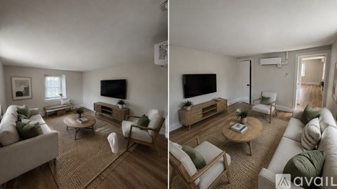 A living room with a white couch and a wooden coffee table.