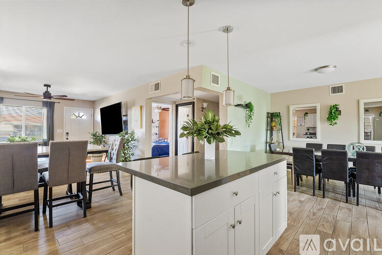 A kitchen with a dining table and chairs.