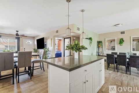 A kitchen with a dining table and chairs.
