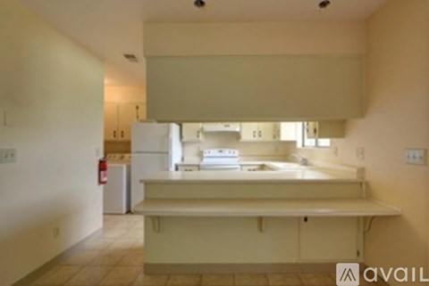 A kitchen with a fridge and a counter top.