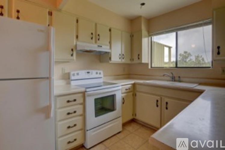 A kitchen with a white fridge and white appliances.