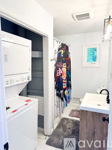 A small laundry room with a washer and dryer.