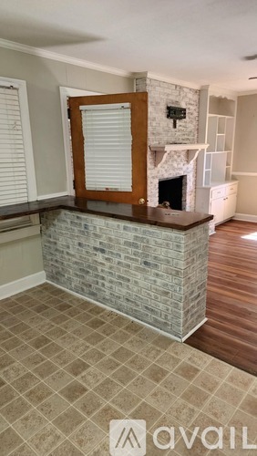 A room with a fireplace and a tiled floor.