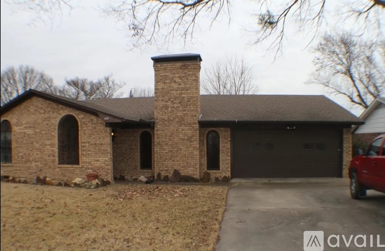 A house with a brick chimney and a garage door.