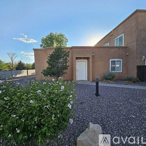 A house with a gravel driveway and a white door.