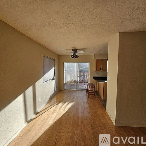 A room with wooden floors and a ceiling fan.