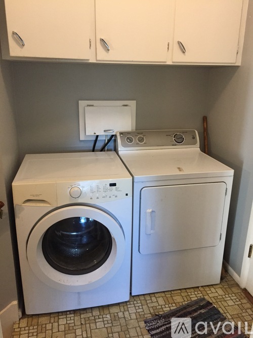 A white washing machine and dryer in a small laundry room.