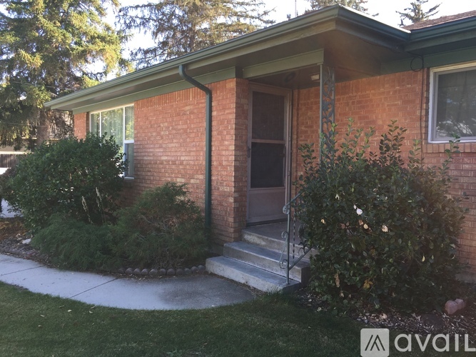 A house with a brick exterior and a brown door.