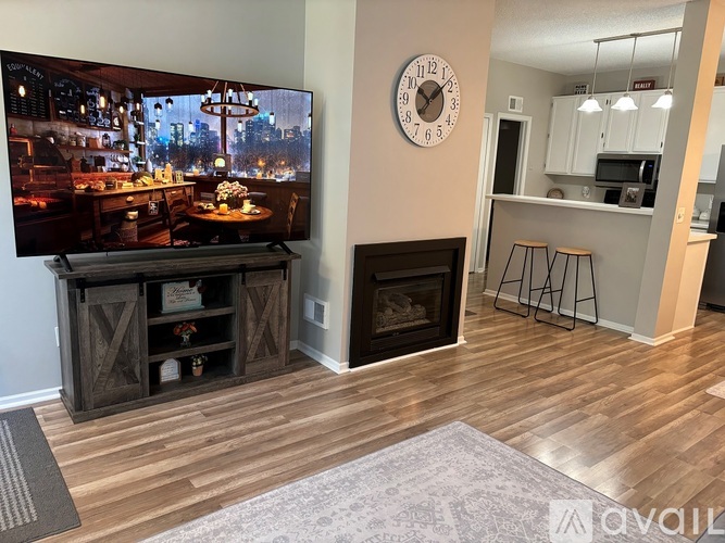 A living room with a flat screen TV and a fireplace.