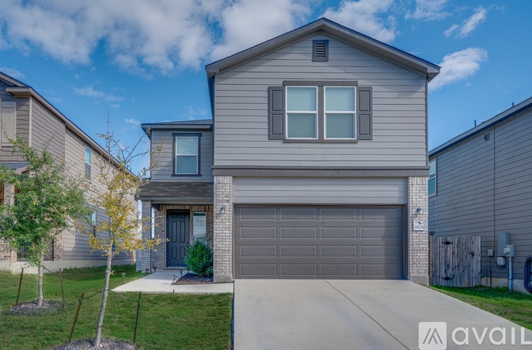 A house with a grey garage door is for sale.