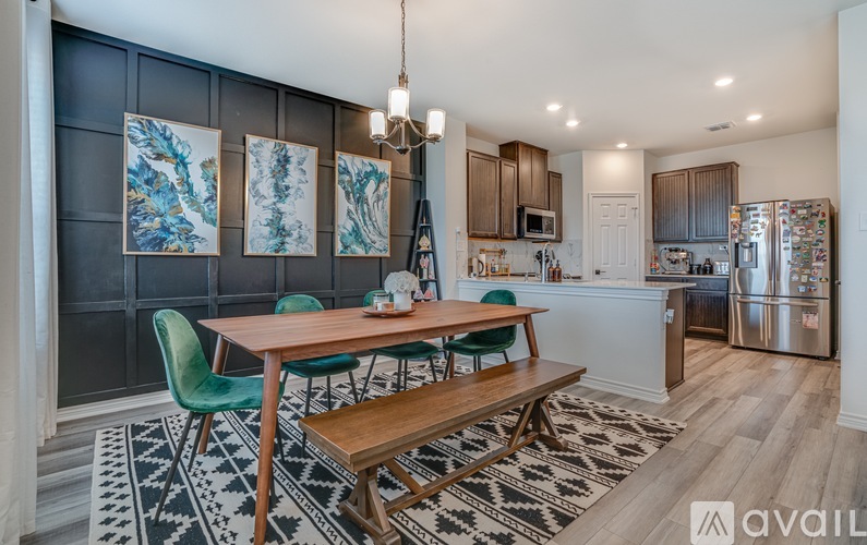 A kitchen with a dining table and chairs.