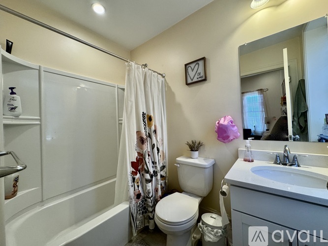 A bathroom with a toilet, sink, and shower.