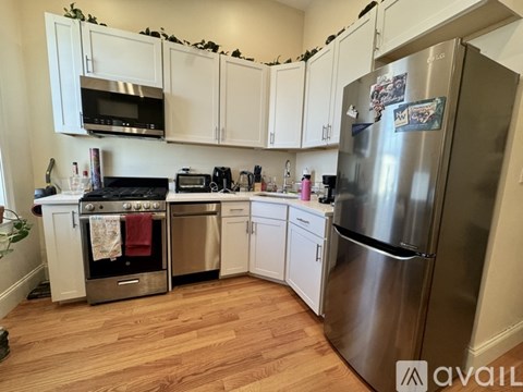 A kitchen with a stainless steel refrigerator, oven, and microwave.