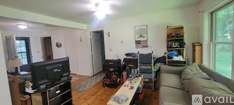 A living room with a television and a couch.