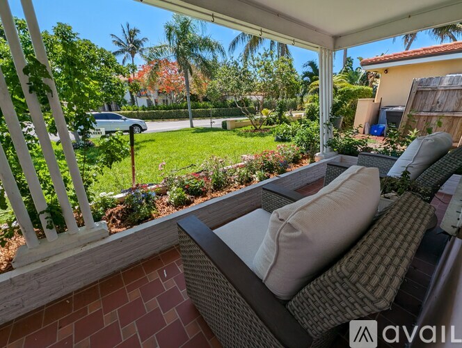 A patio with a couch and a view of a street.